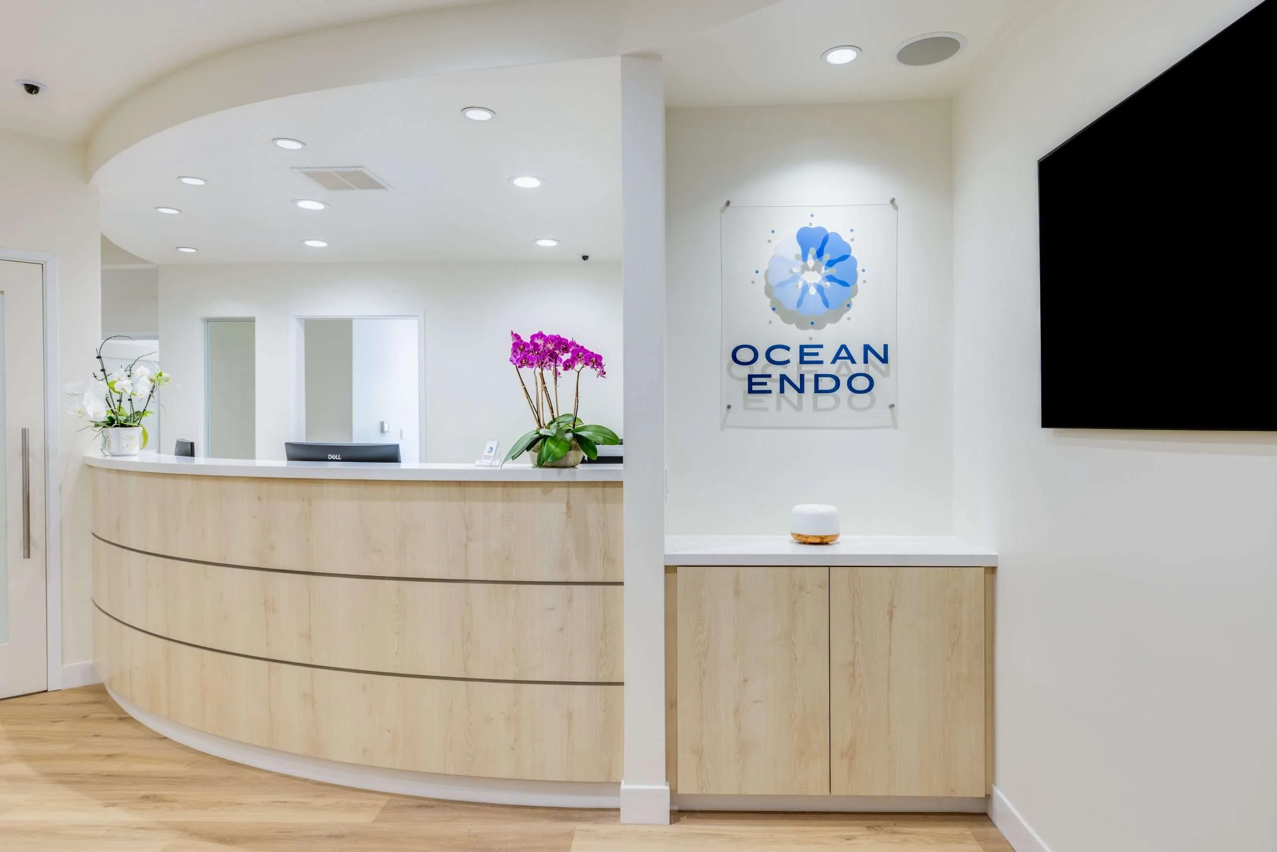 Ocean Endodontics reception with the practice logo on glass